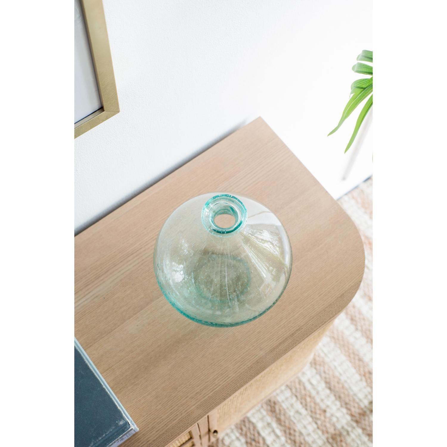 Overhead view of blue glass vase on wood cabinet