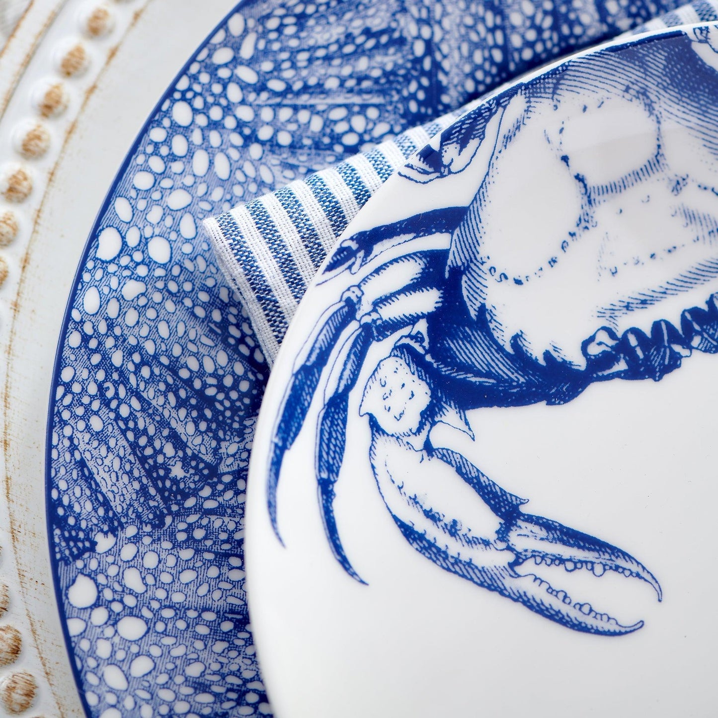 a blue and white plate with a crab on it
