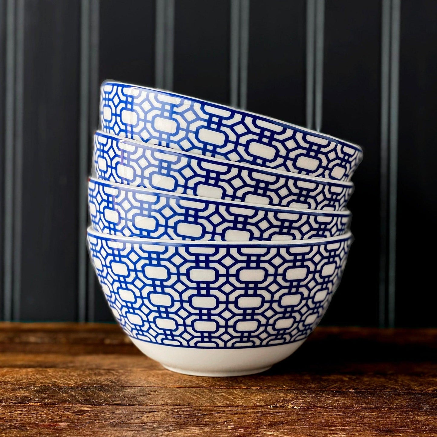 a blue and white bowl sitting on top of a wooden table