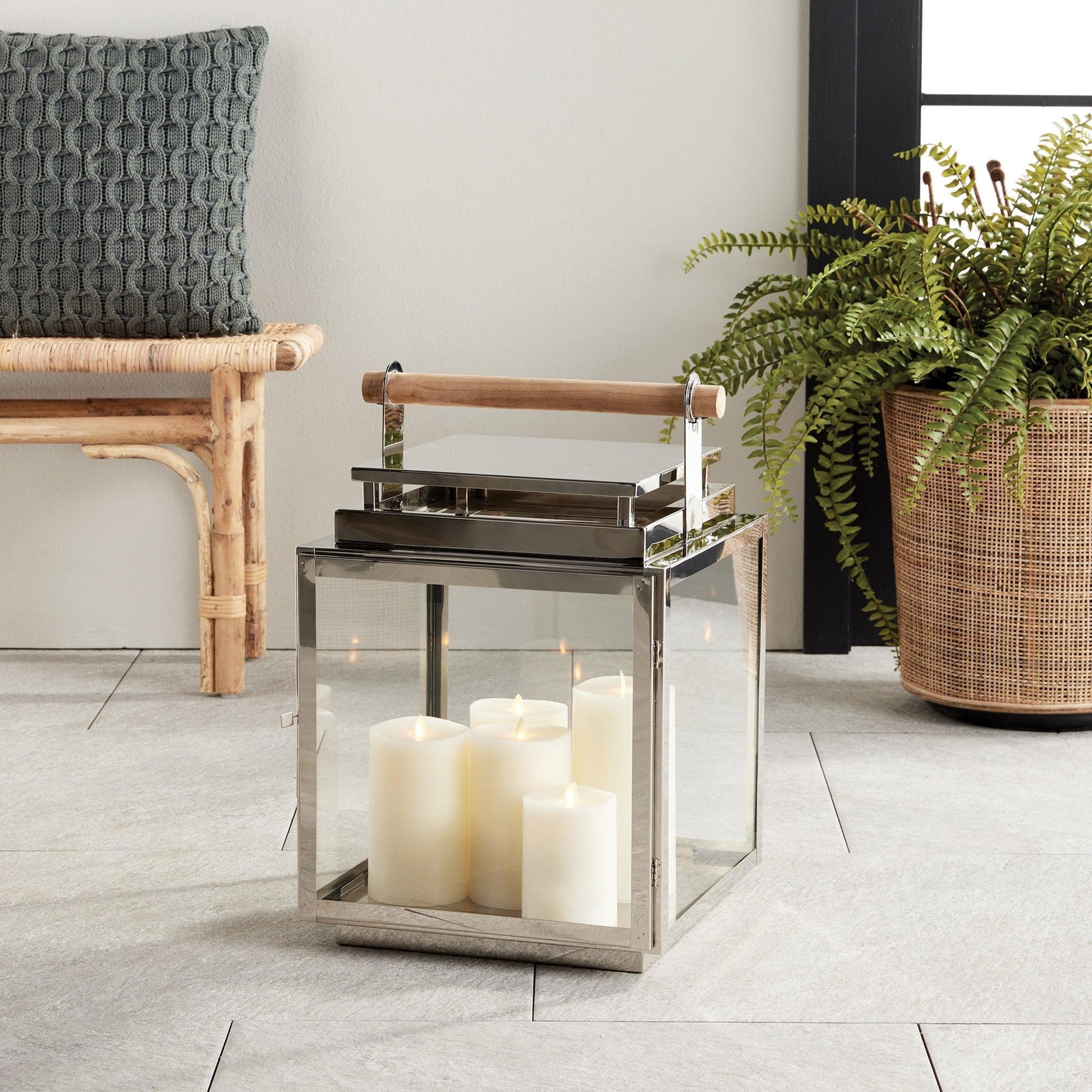 Silver lantern with wood handle in a living room