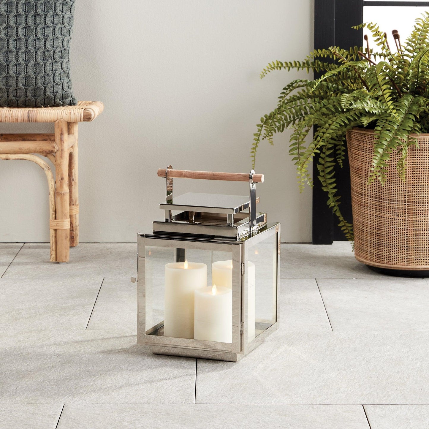 Silver lantern with wood handle in a living room