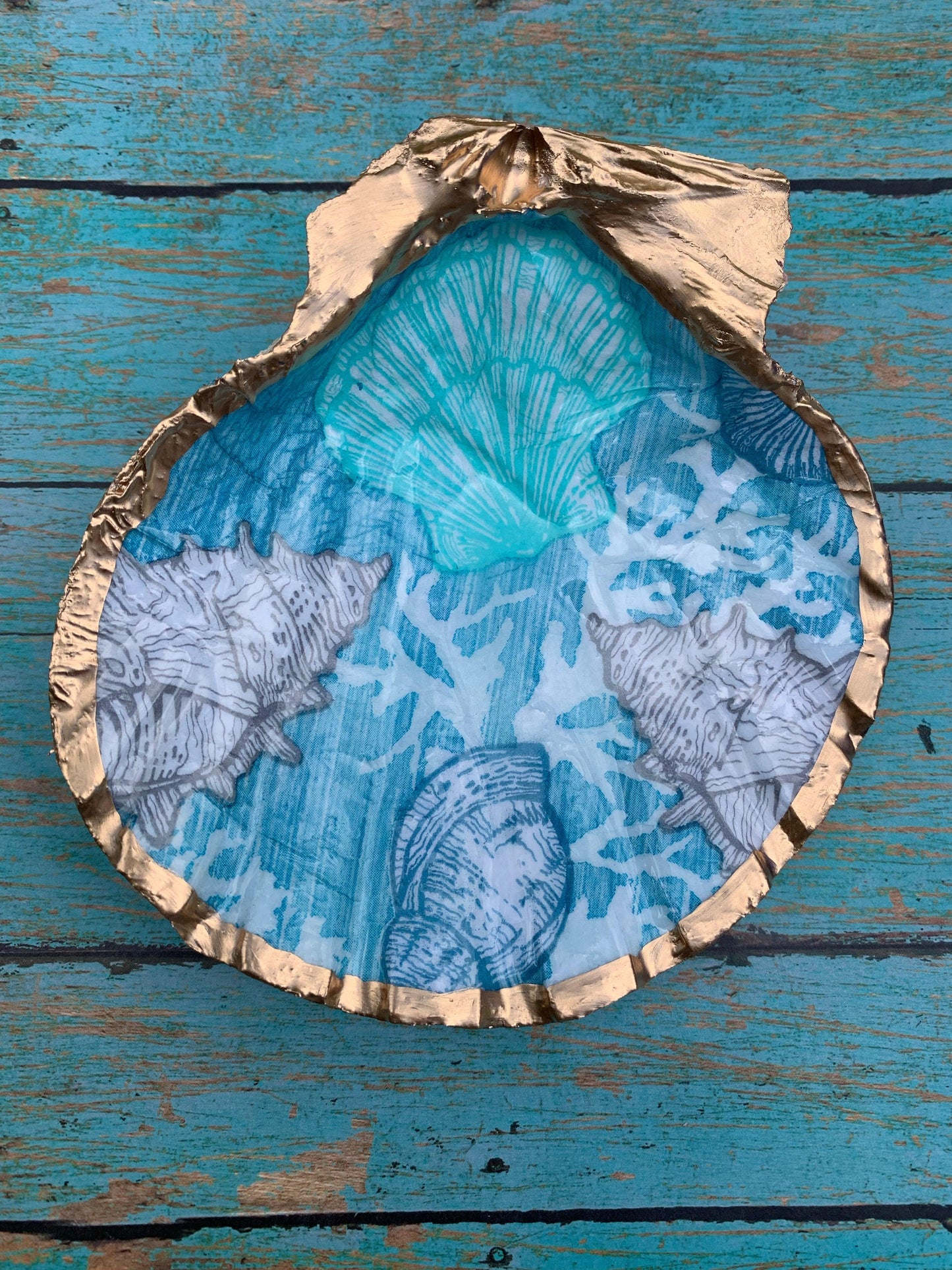 Gold shell with blue painted design