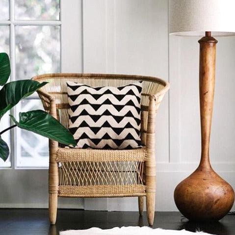 a living room with a chair and a lamp