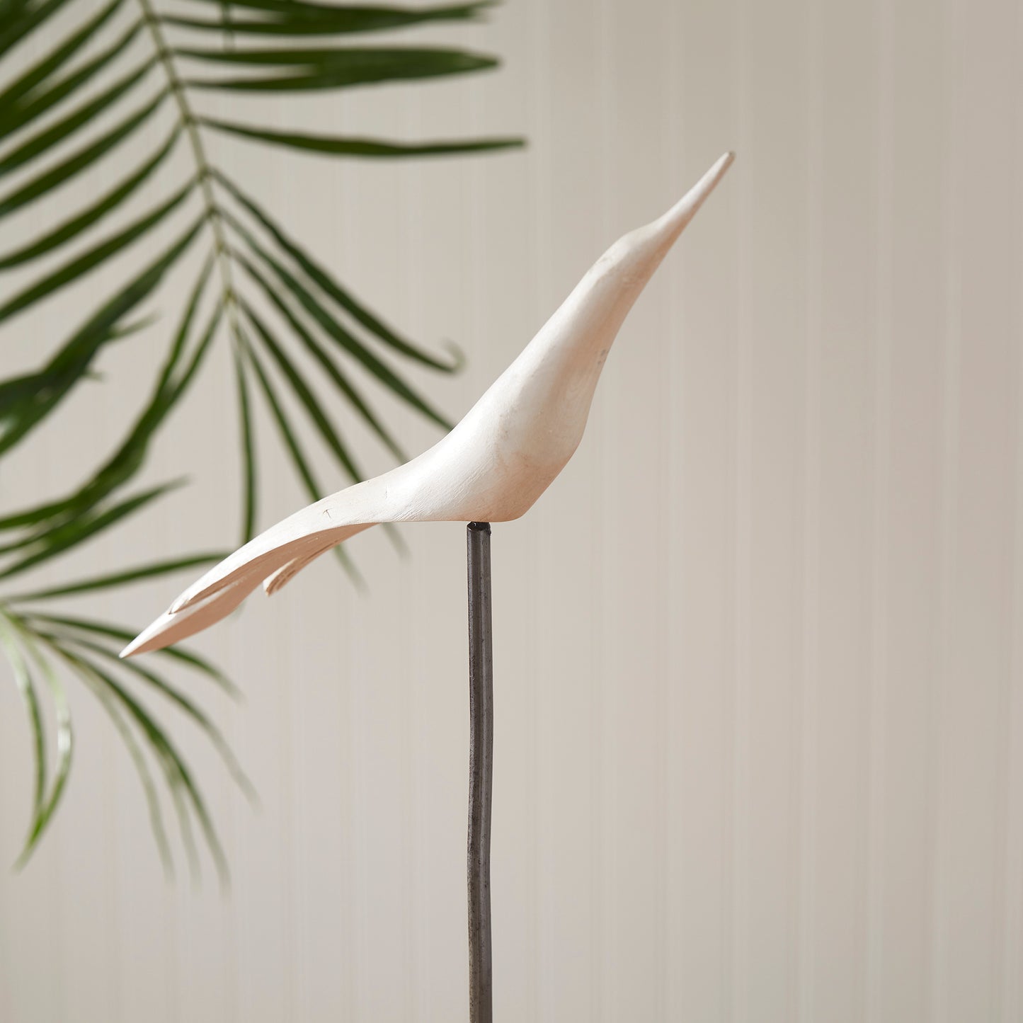 close up of white wooden bird