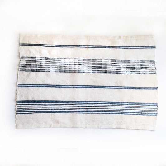 a blue and white striped towel on a white surface