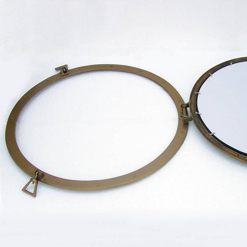 a mirror with a metal ring around it