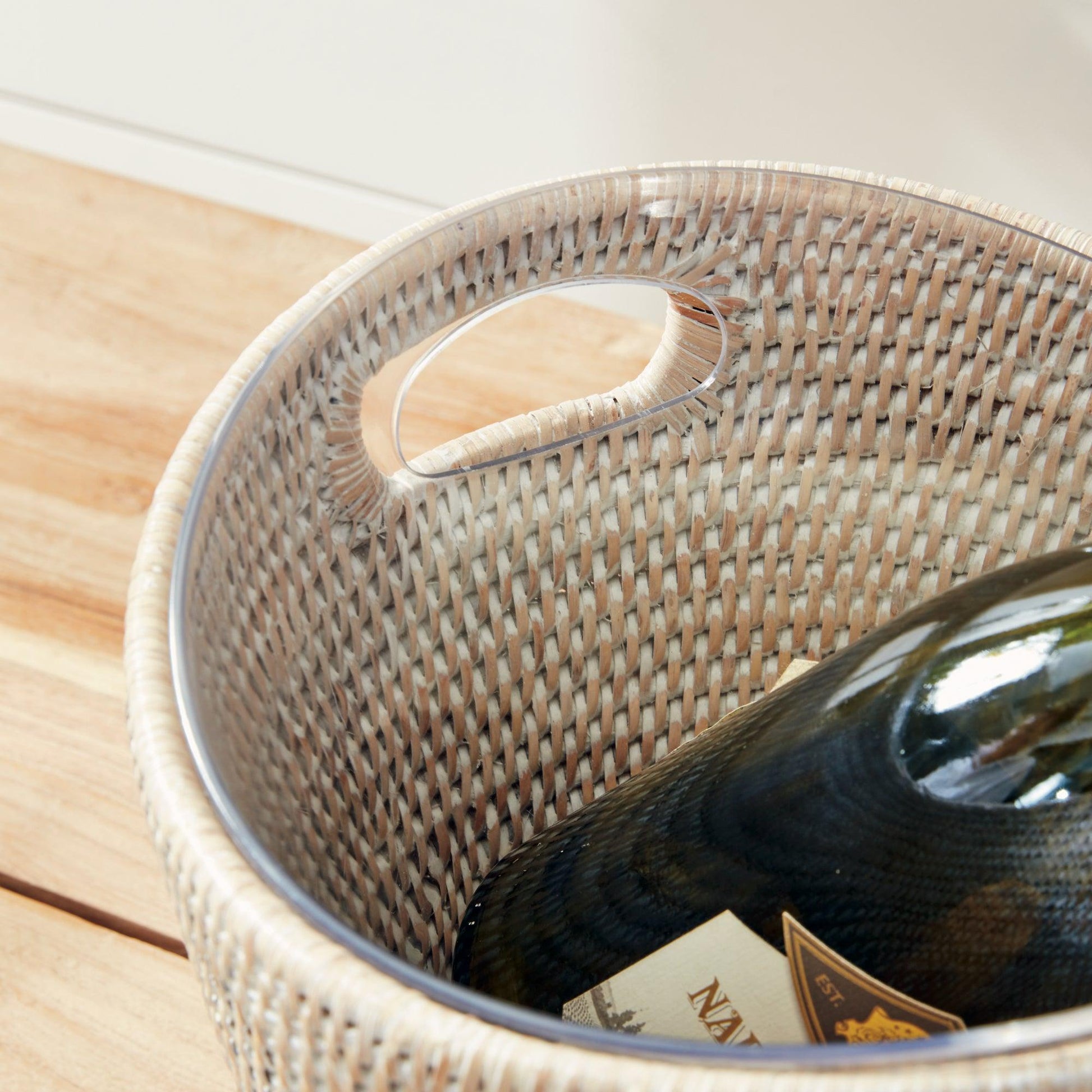 Inside of rattan ice bucket with bottle of wine