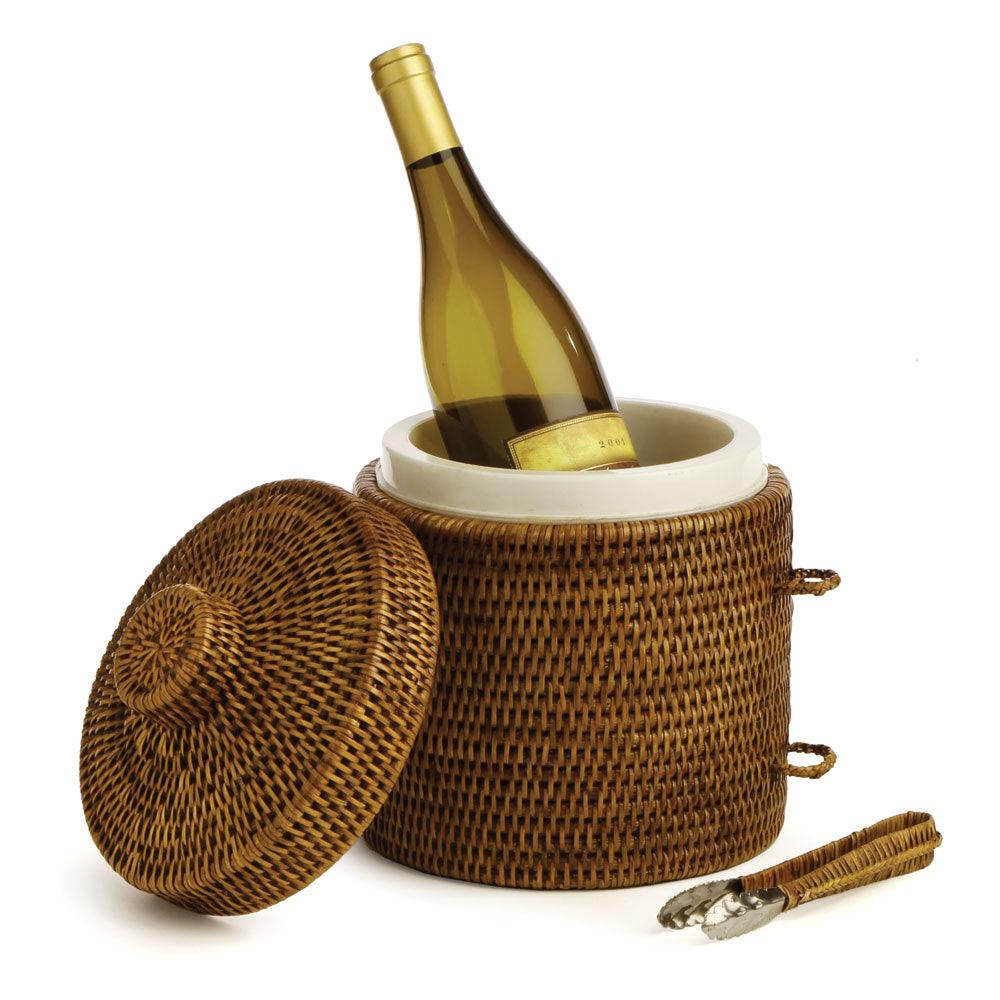 A brown rattan ice bucket with bottle of wine
