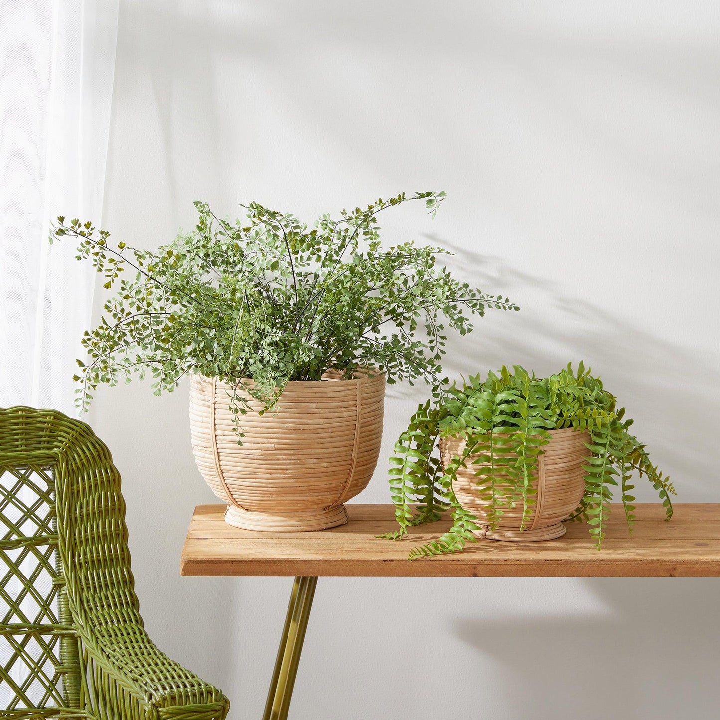 a wooden table topped with two potted plants