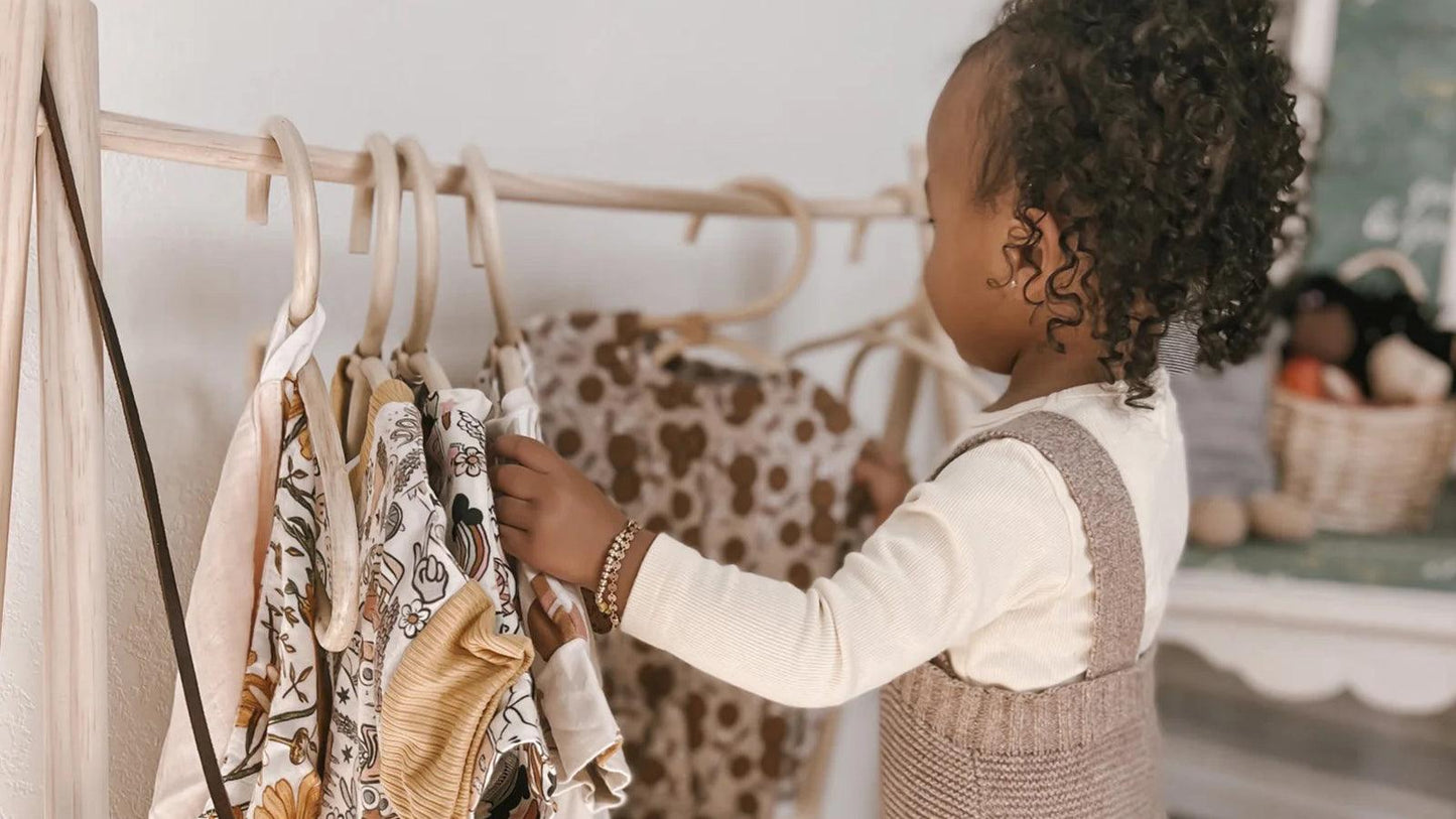 close up of childrens hanging clothes in closet