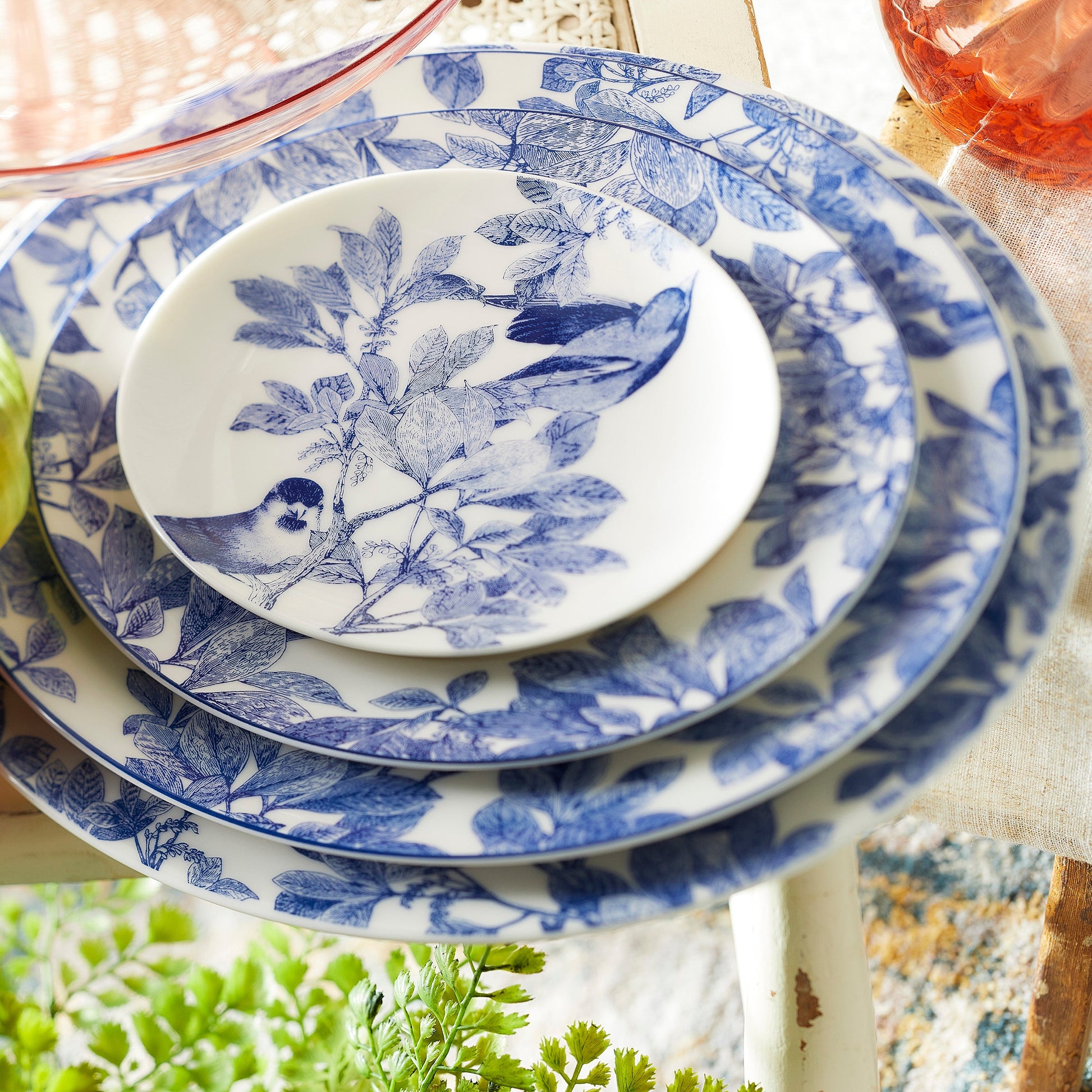 four stacked blue and white dishes