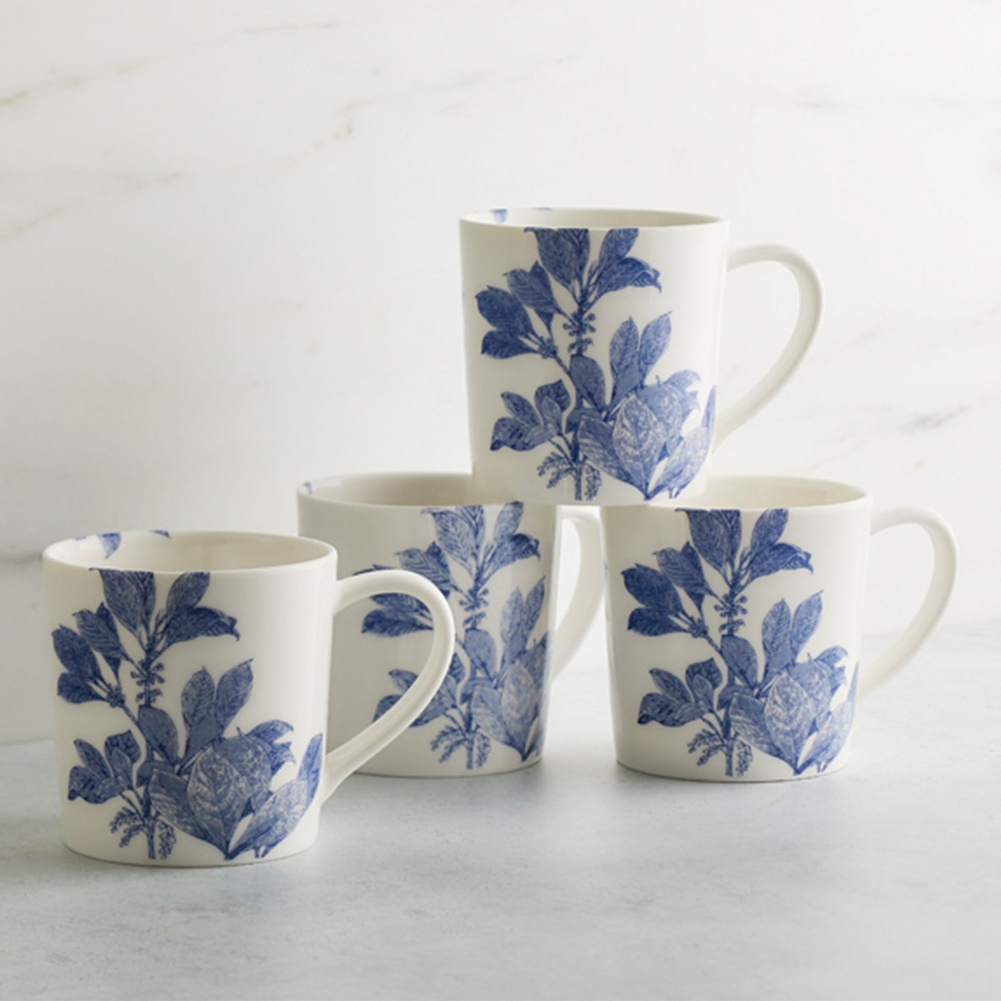 set of four white mugs with blue flowers