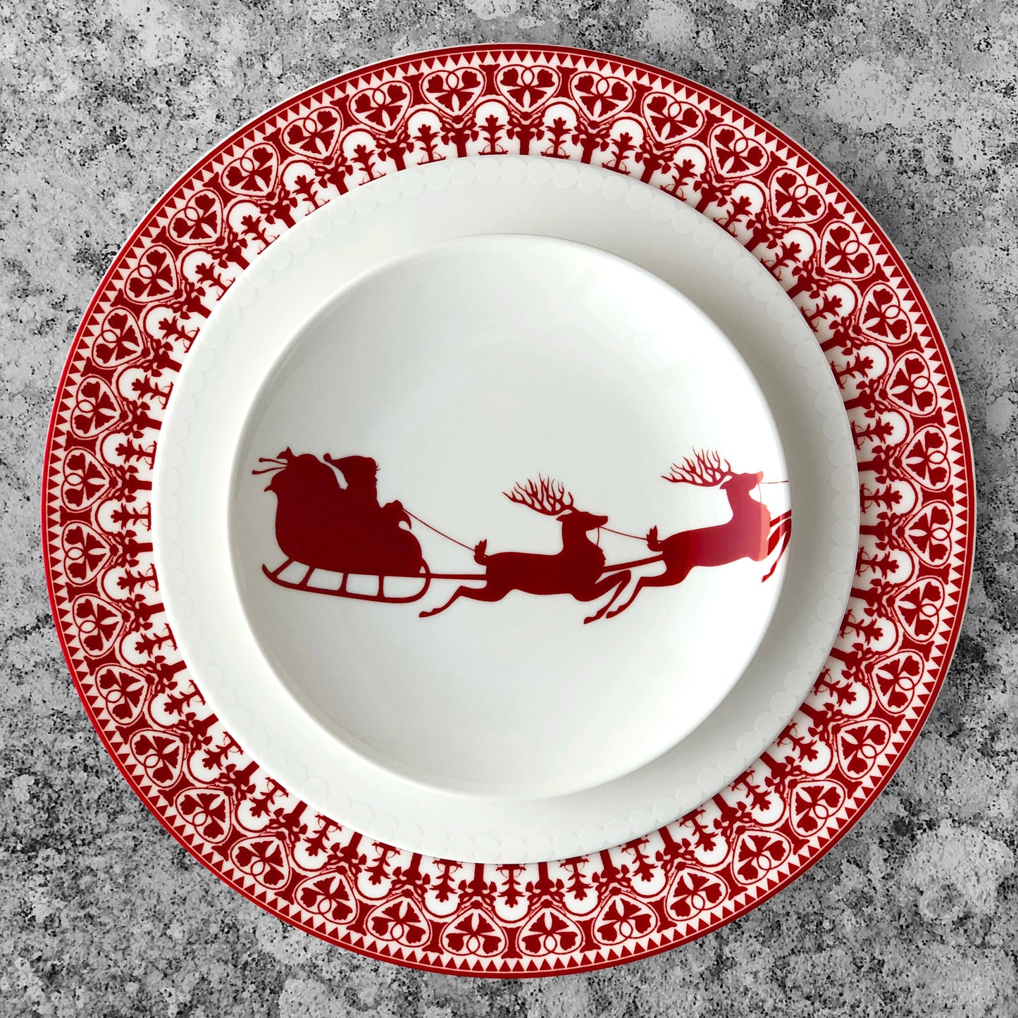 red and white sleigh plate on larger red and white plate