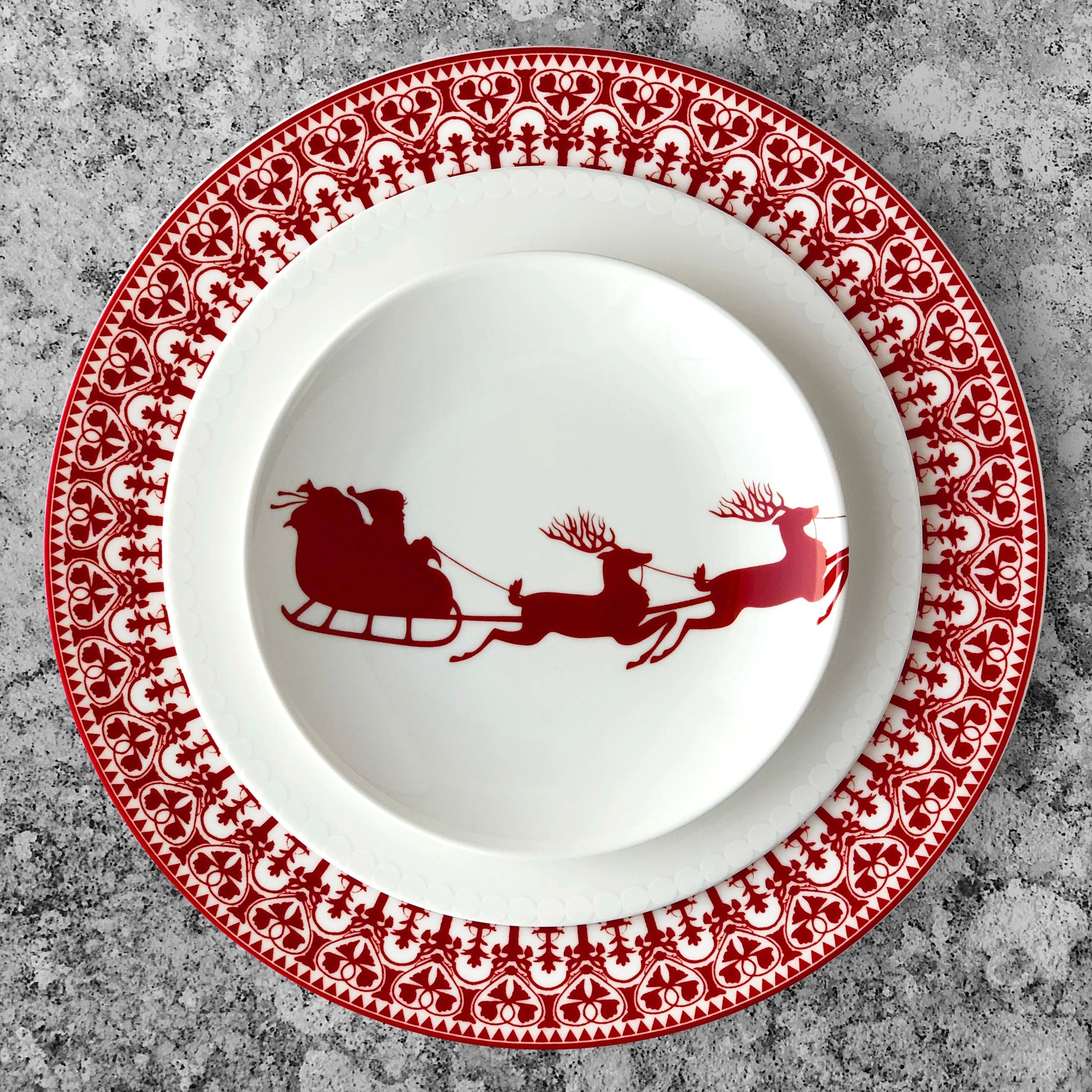 red and white sleigh plate on larger red and white plate