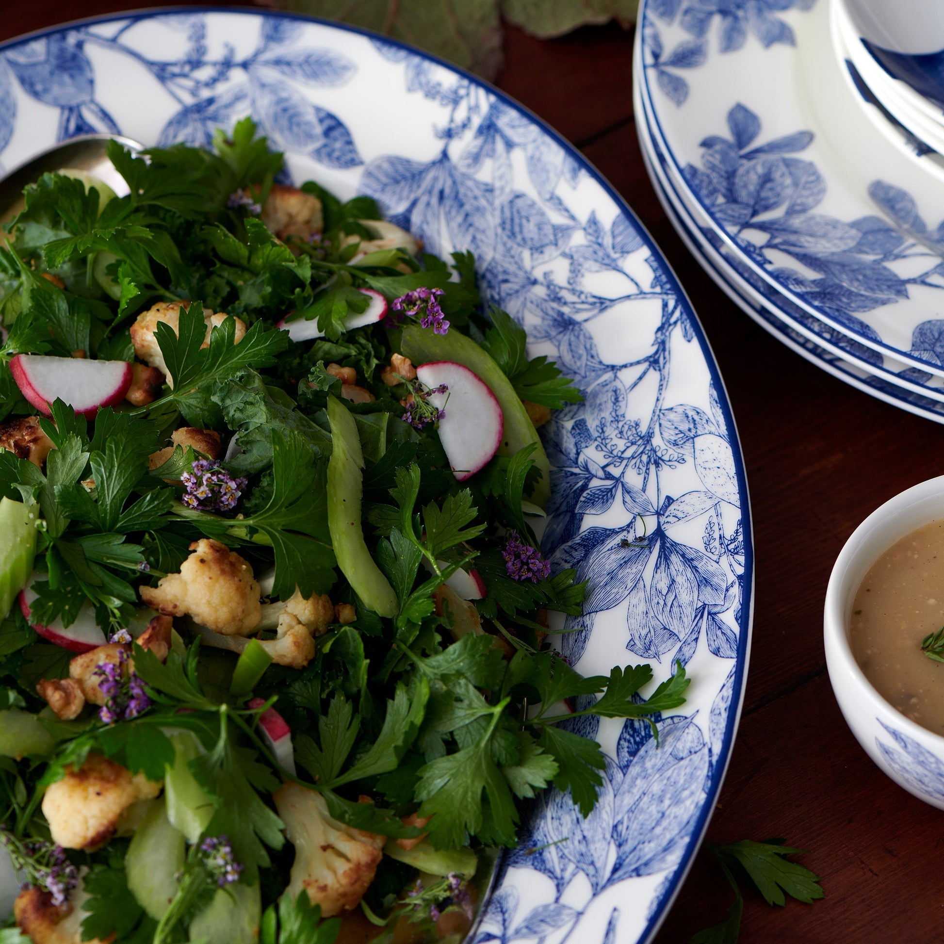 close up of a salad on a blue and white platter