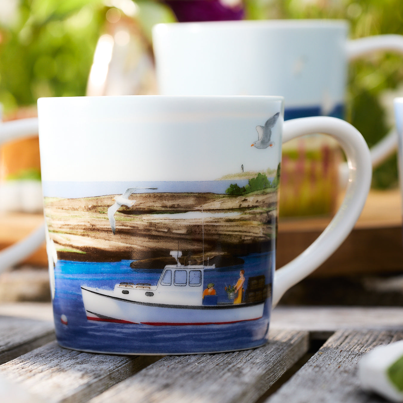 close up of coffee mug with a boat painted on it