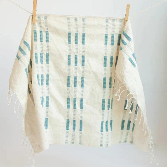 a blue and white towel hanging on a clothes line