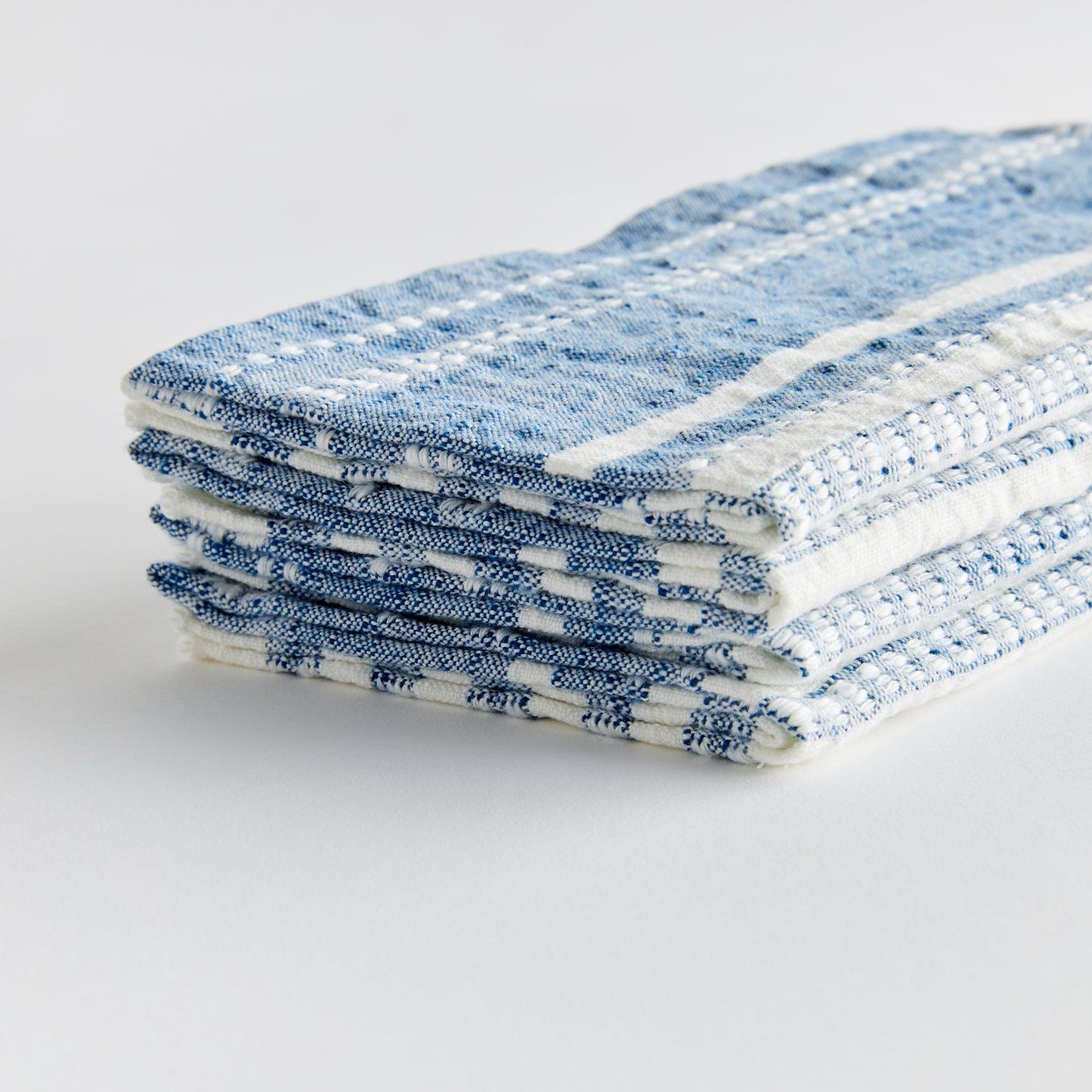 stack of blue and white napkins