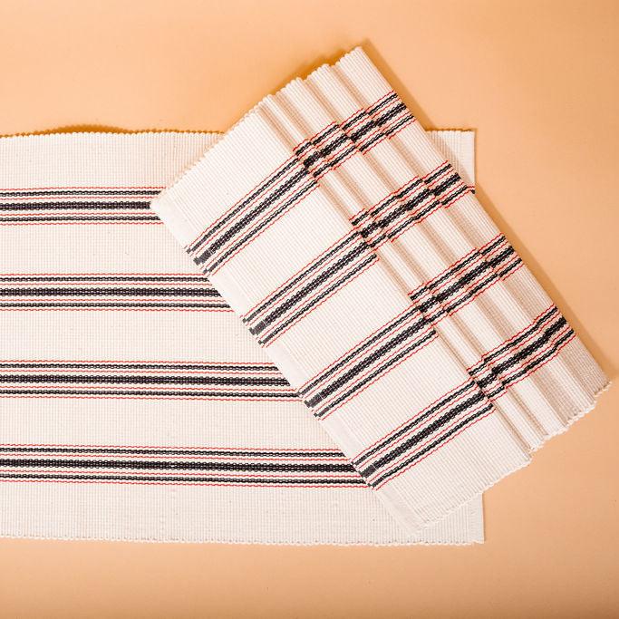 set of five white placemats with blue and red stripes