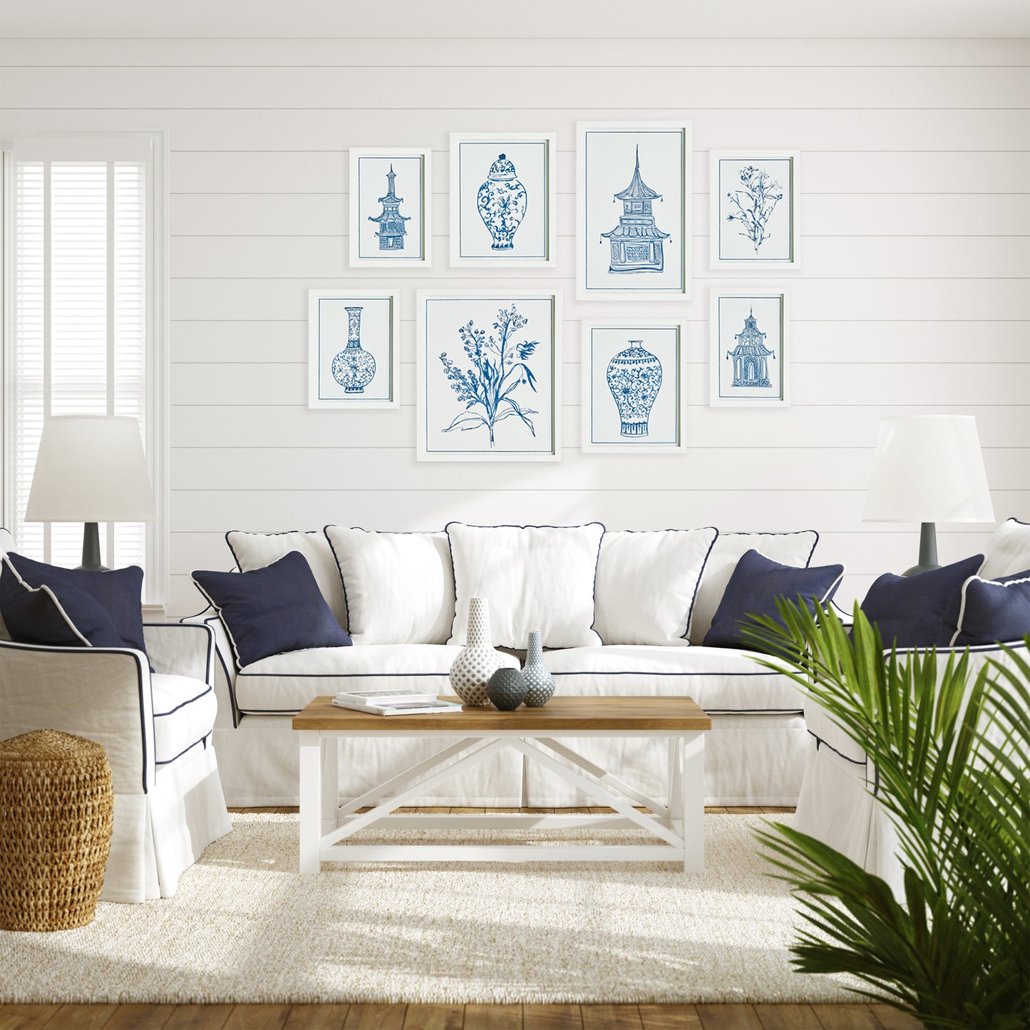 blue and white living room with 8 art prints on a white shiplap wall