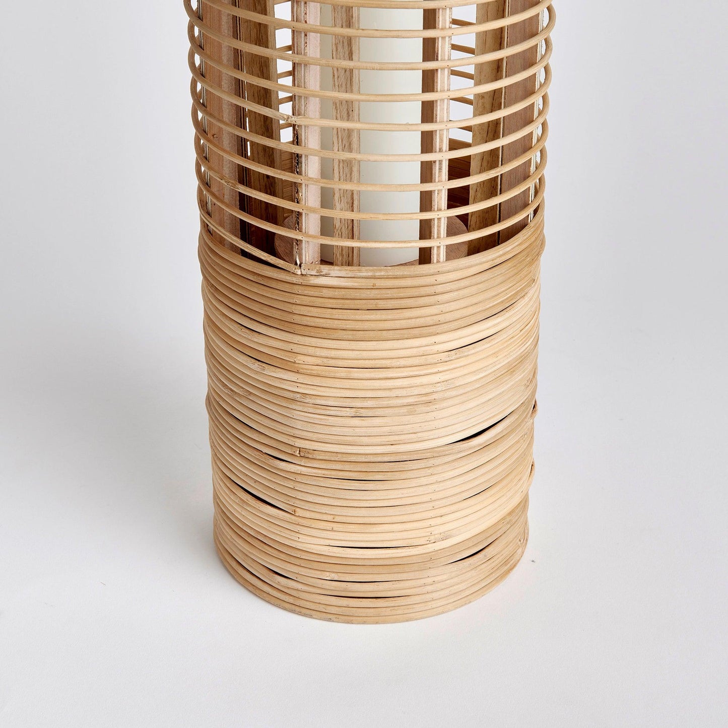 a tall wooden vase with a white background
