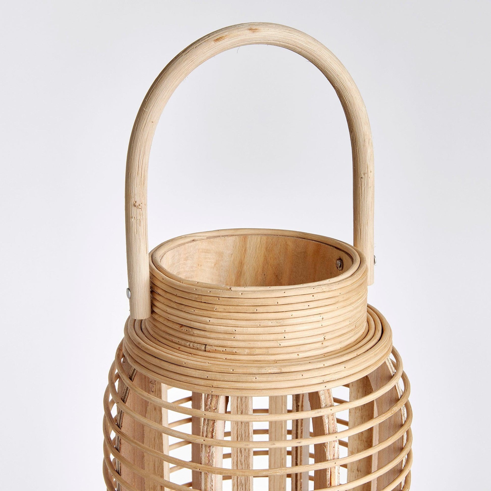 a wooden basket with a handle on a white background