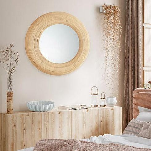 a bedroom with a bed and a mirror on the wall