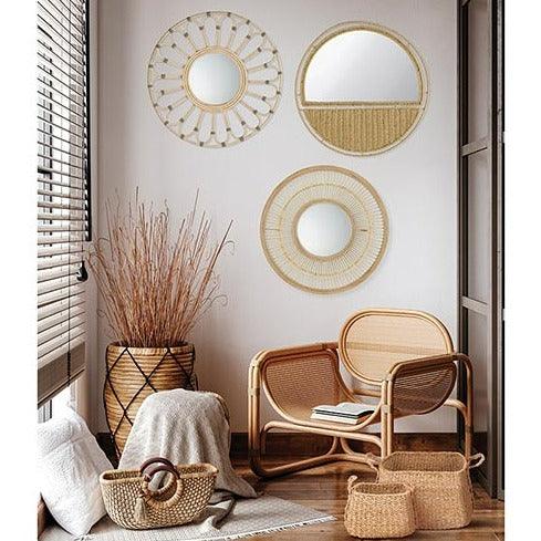 a living room with wicker furniture and mirrors on the wall