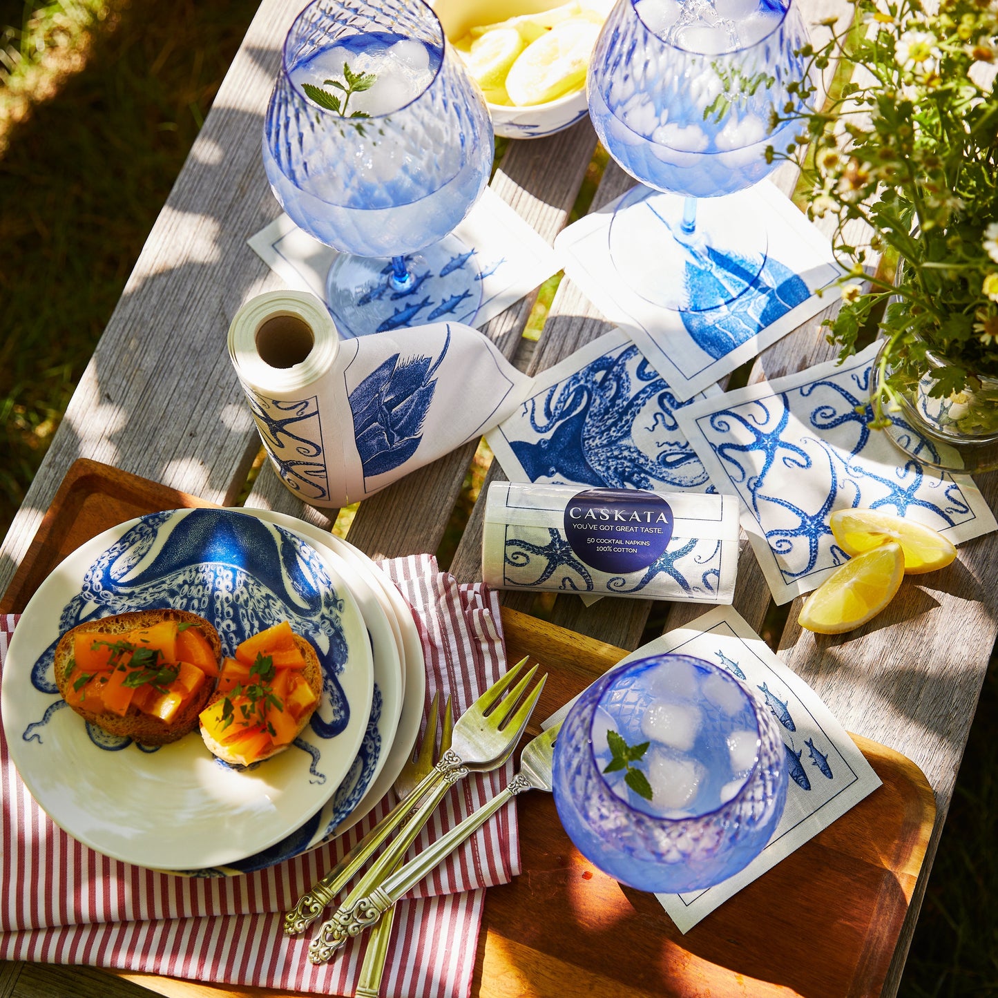 wood table with blue and white dinnerware and napkins