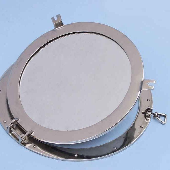 a porthole mirror with a metal frame on a blue background