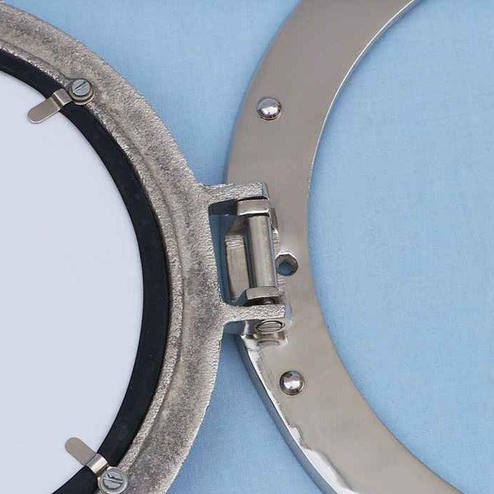 a close up of a chrome porthole mirror