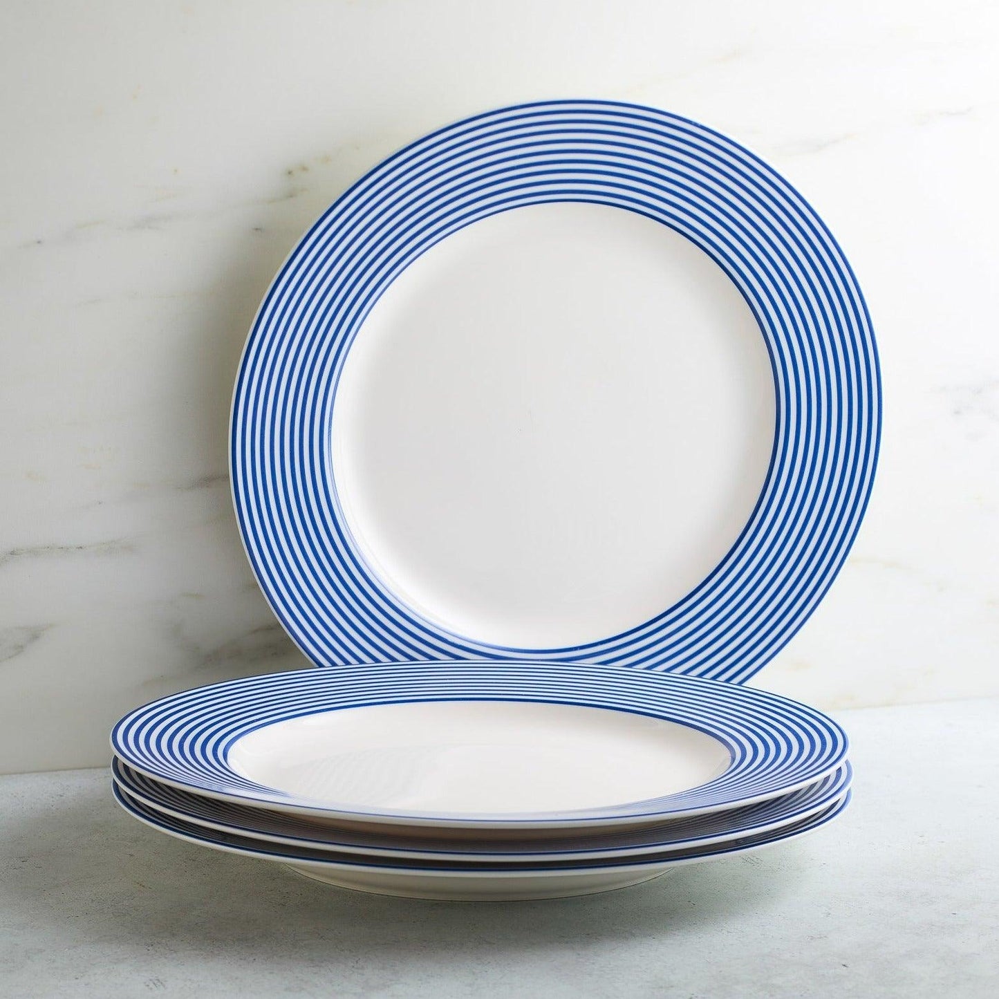 a stack of blue and white plates sitting on top of a table