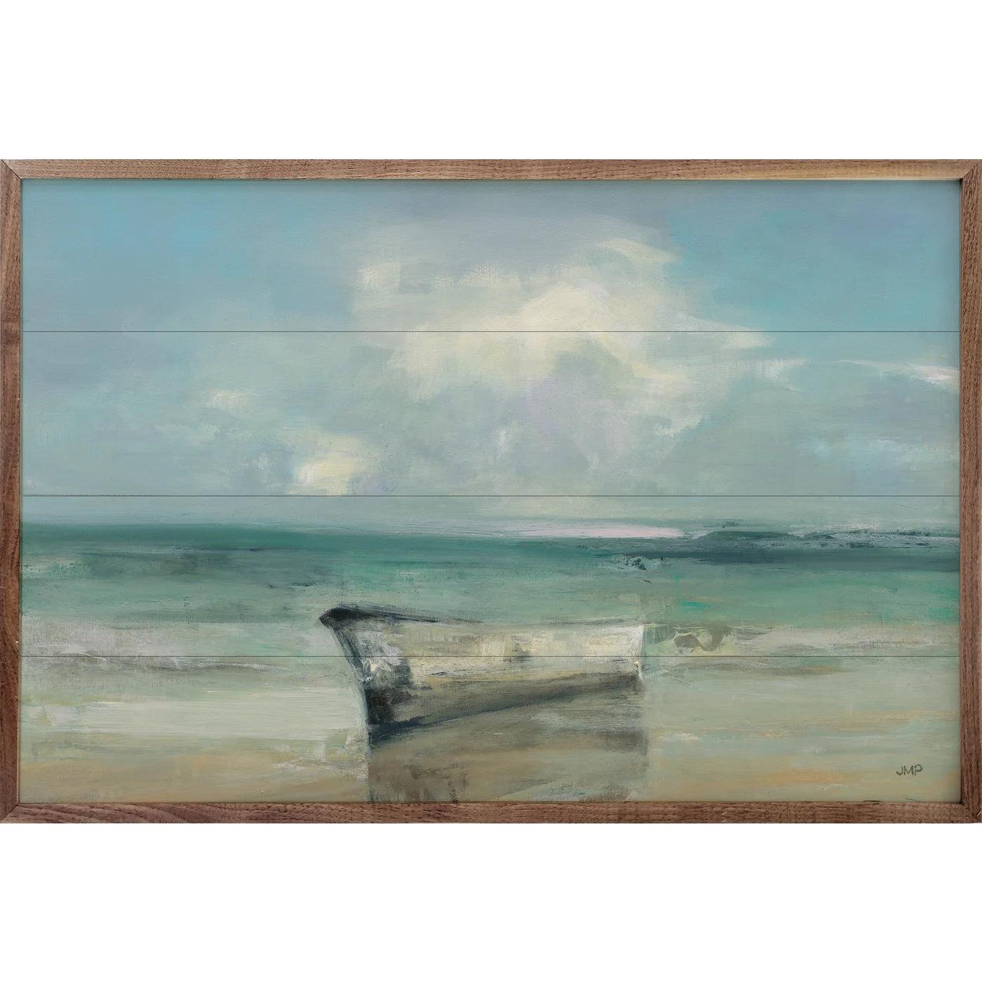 a white boat on a beach with the ocean in the background