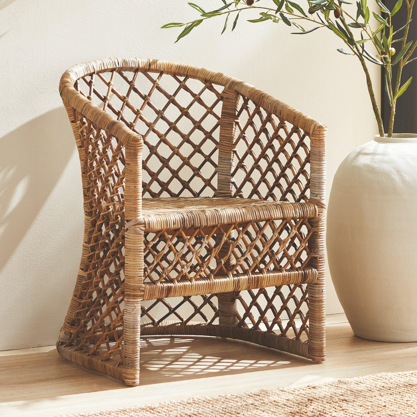 Rattan chair next to a floor vase