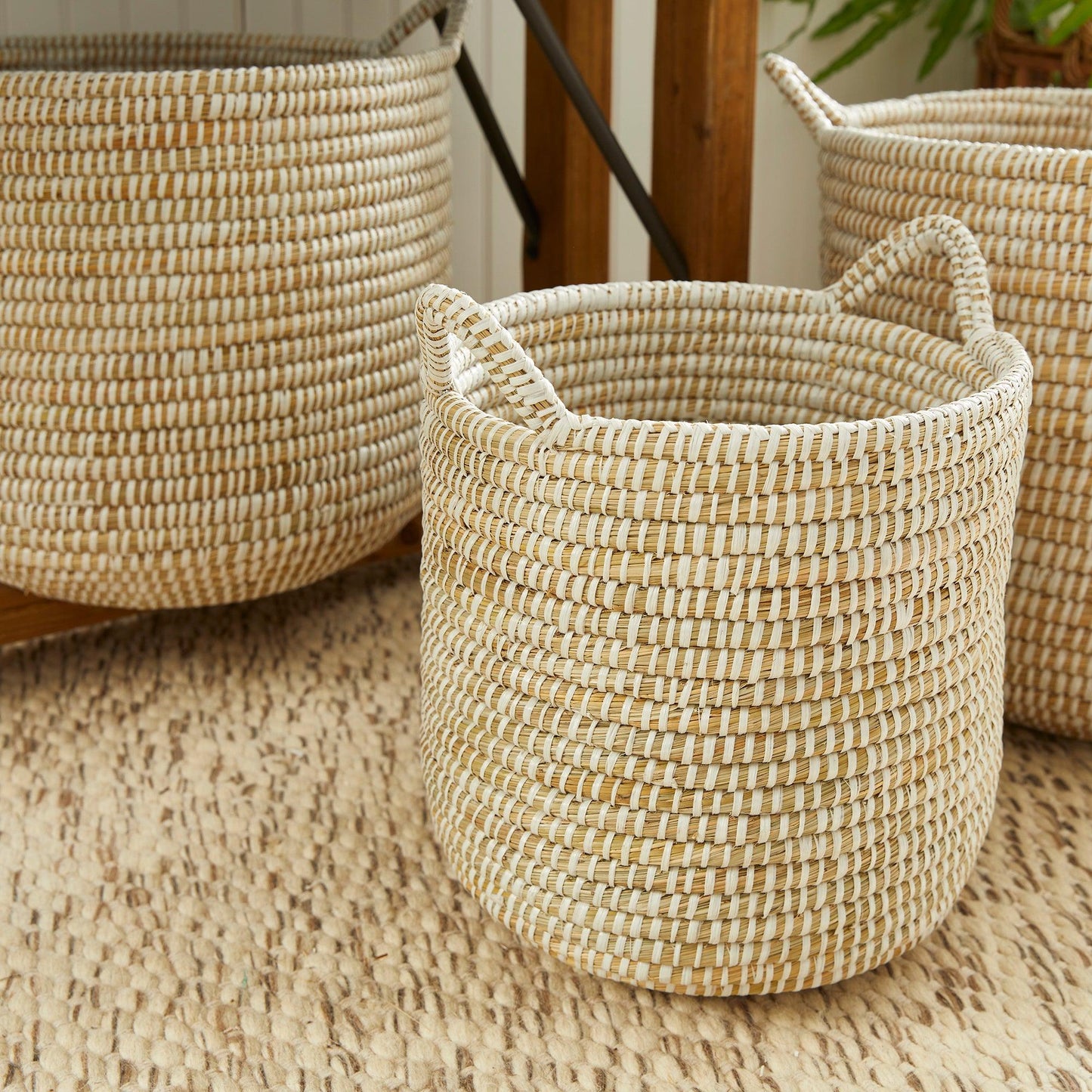 three woven baskets sitting on top of a rug