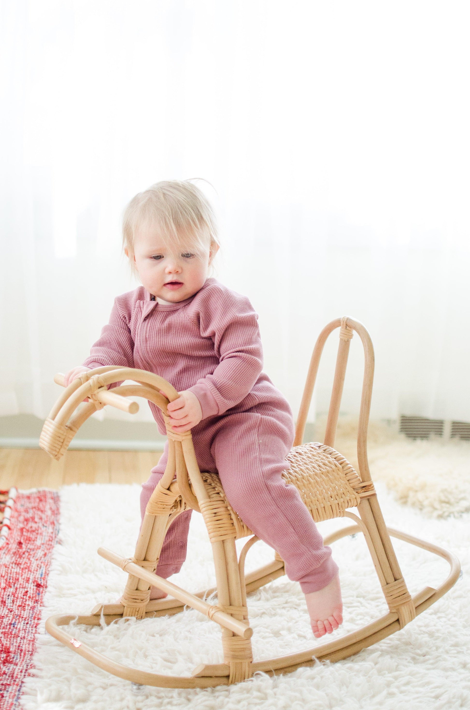 toddler on a rattan rocking horse