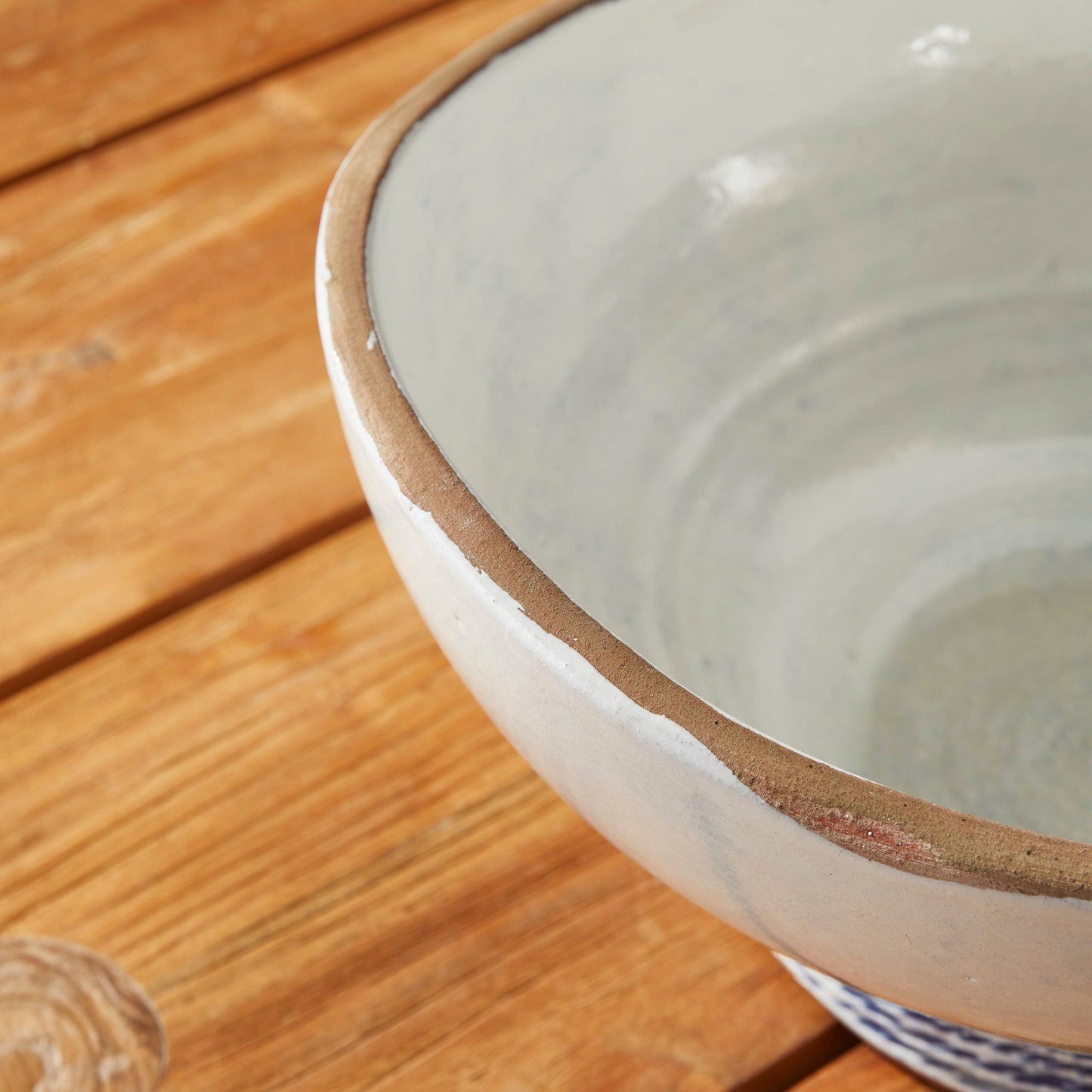 a white bowl sitting on top of a wooden table