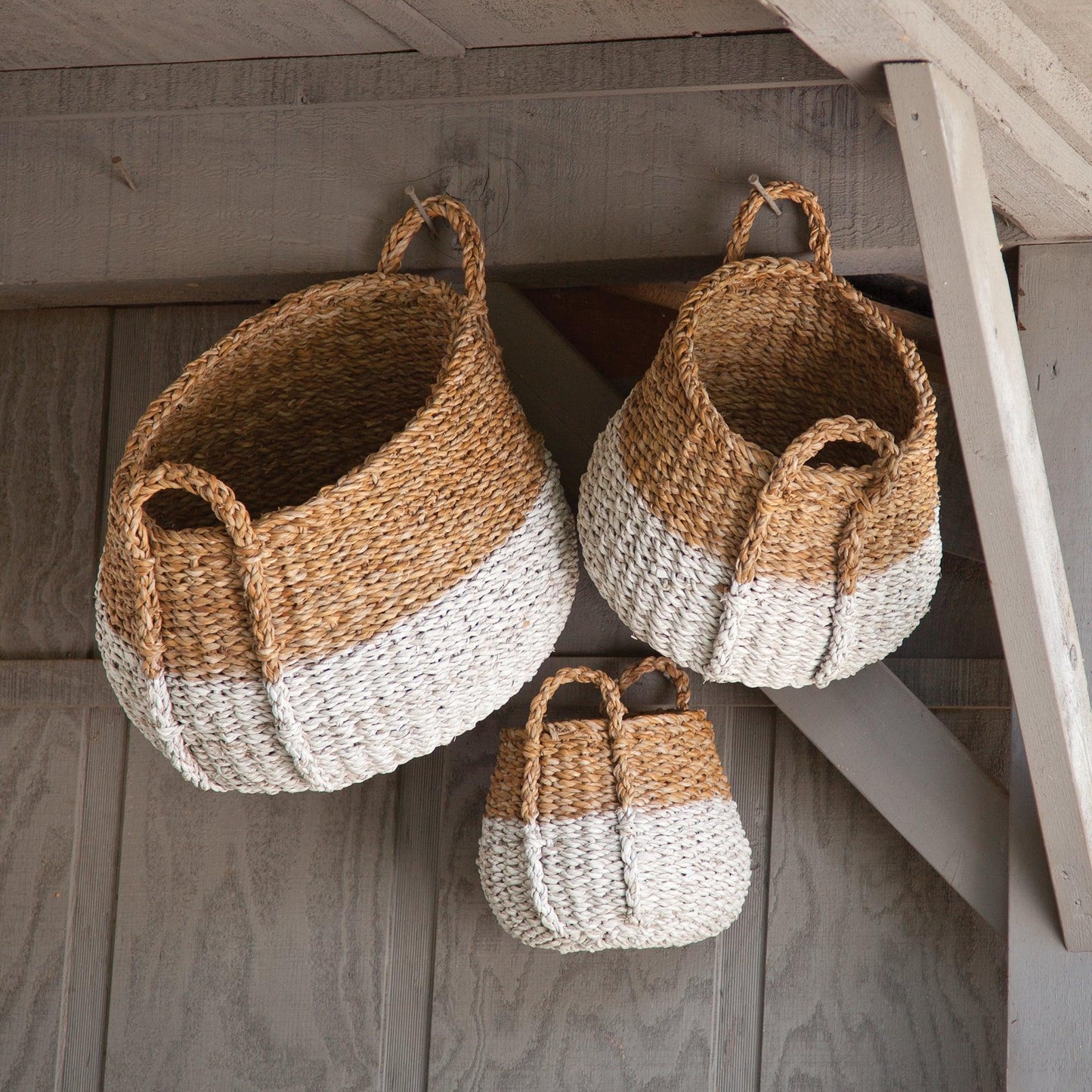 a couple of baskets hanging from the side of a building
