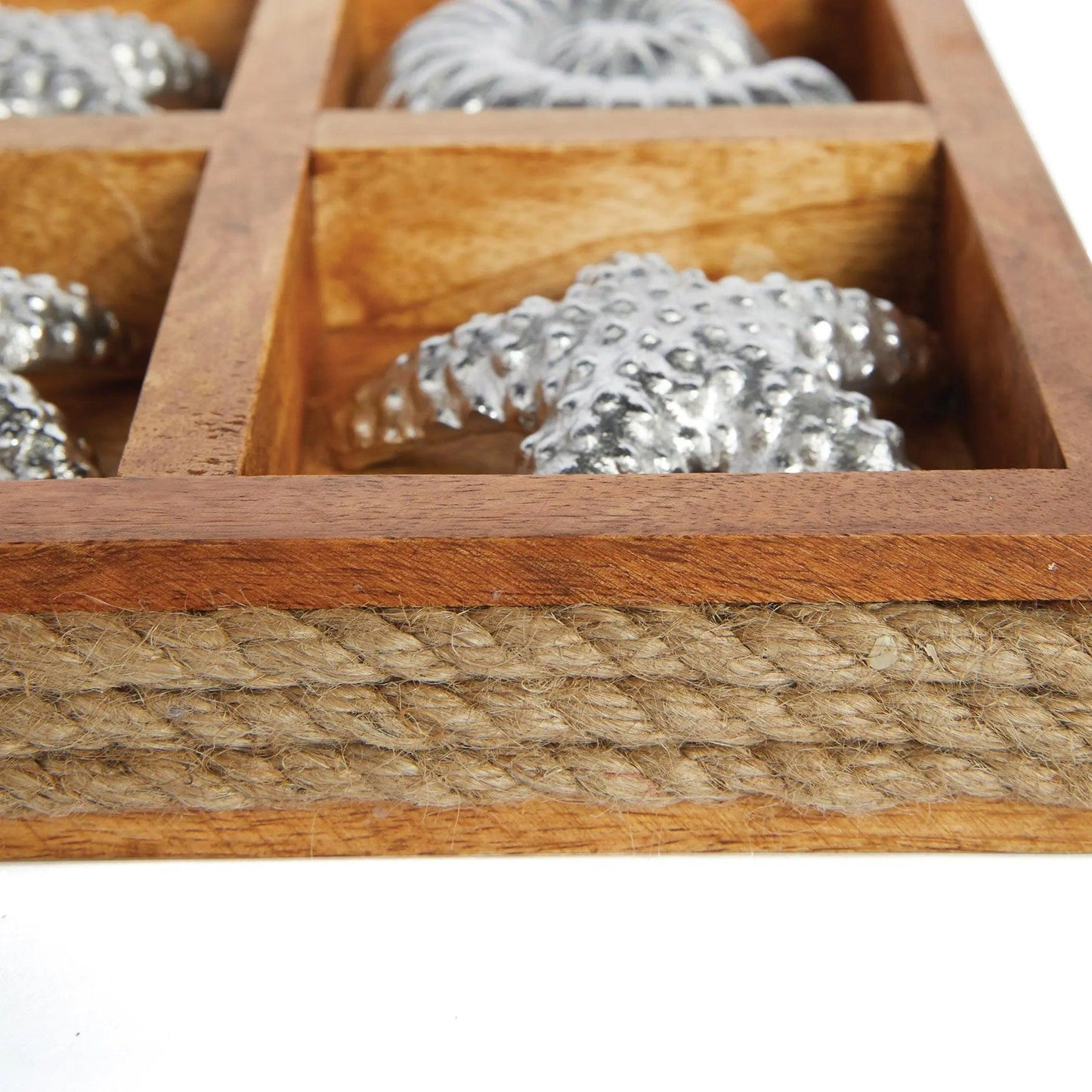 Close up of wood and rope tic tac toe board with silver star piece