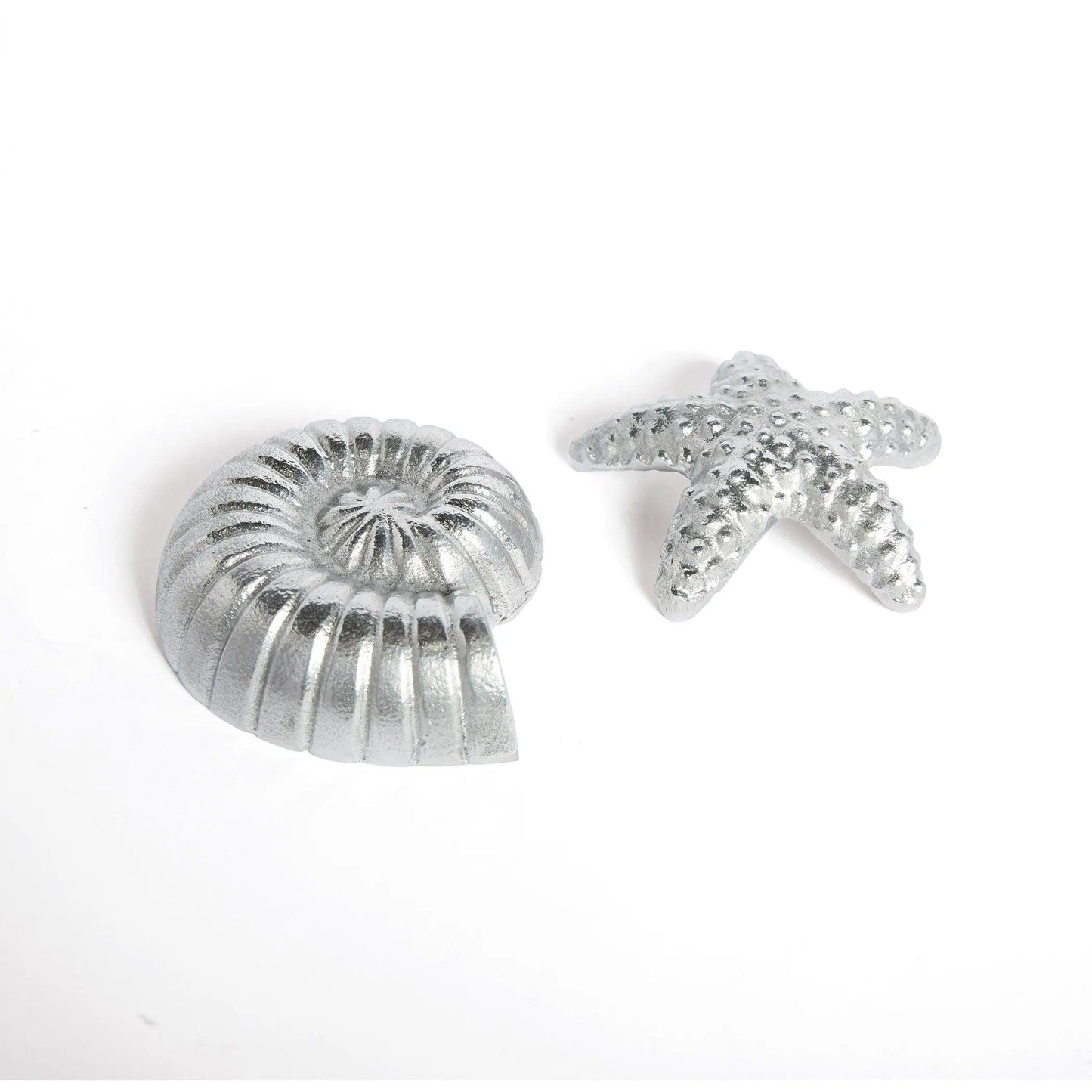 Two silver game pieces