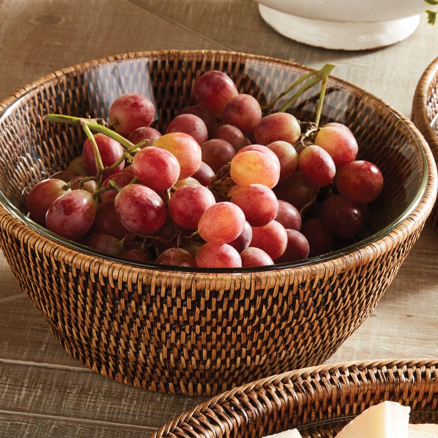 rattan serving bowl filled with red grapes