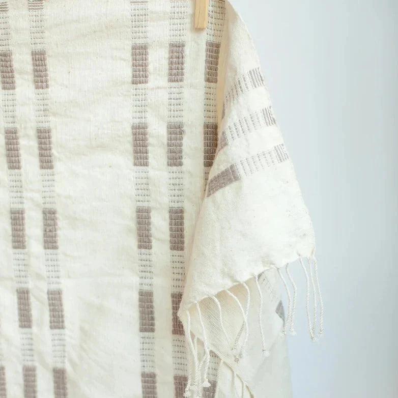 a white towel hanging on a clothes line