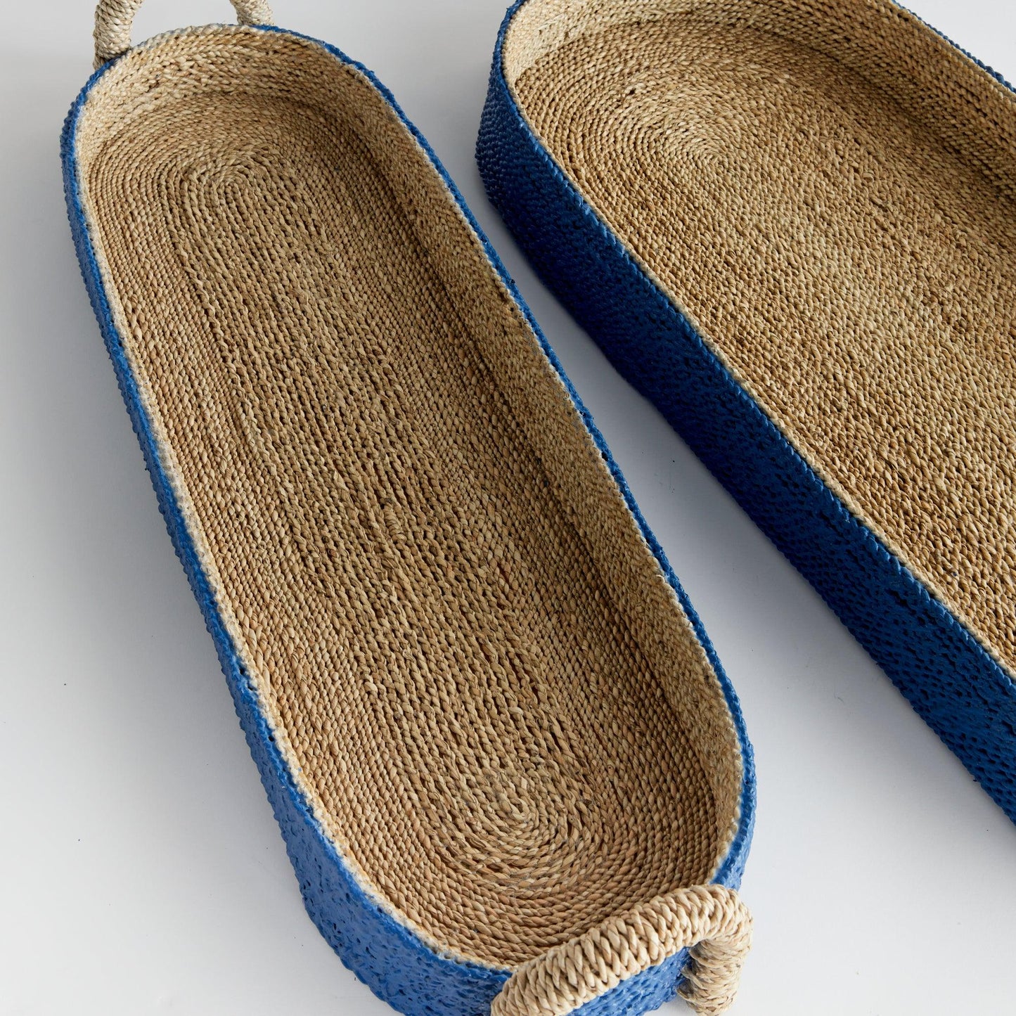 a pair of blue and tan oval baskets