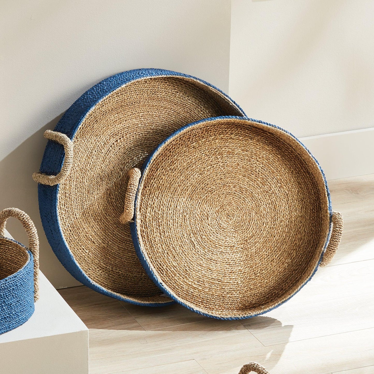 a set of three baskets sitting on top of a wooden floor