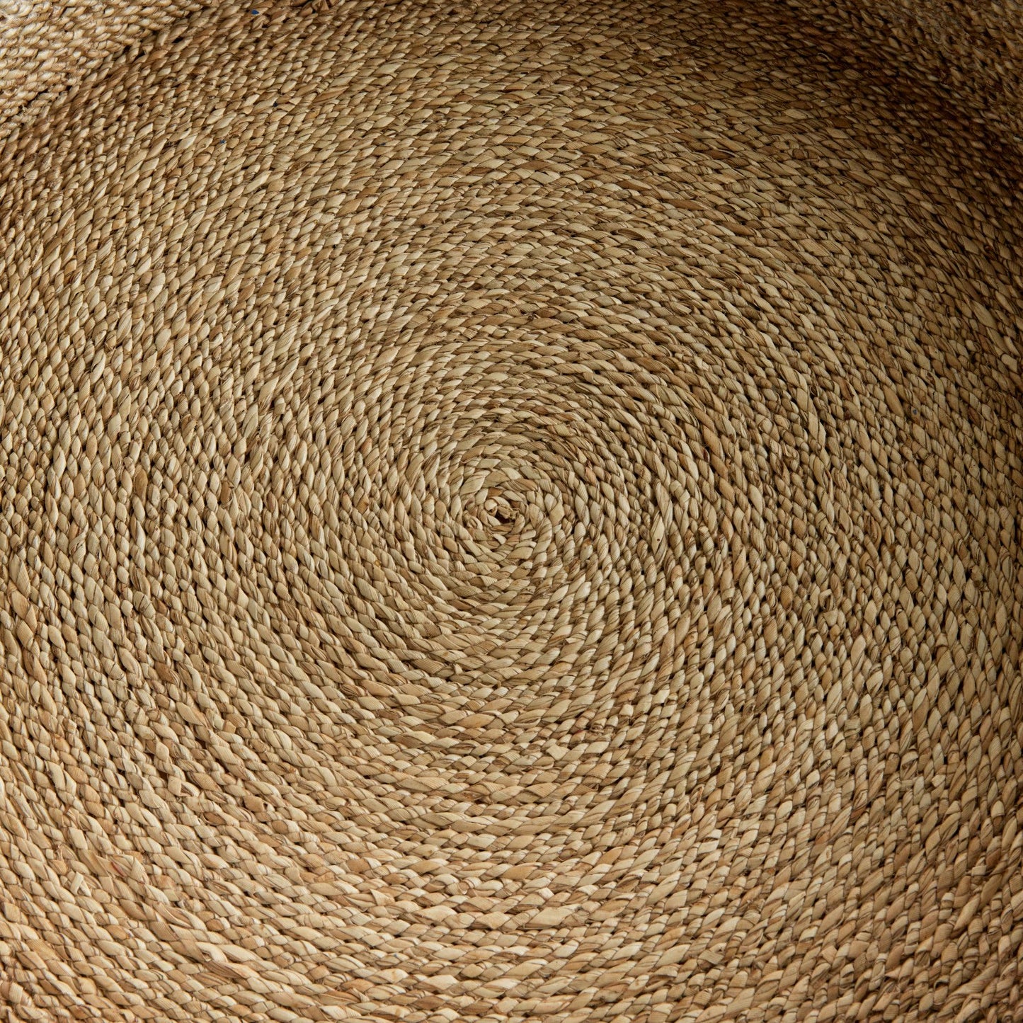 a close up view of a round woven placemat