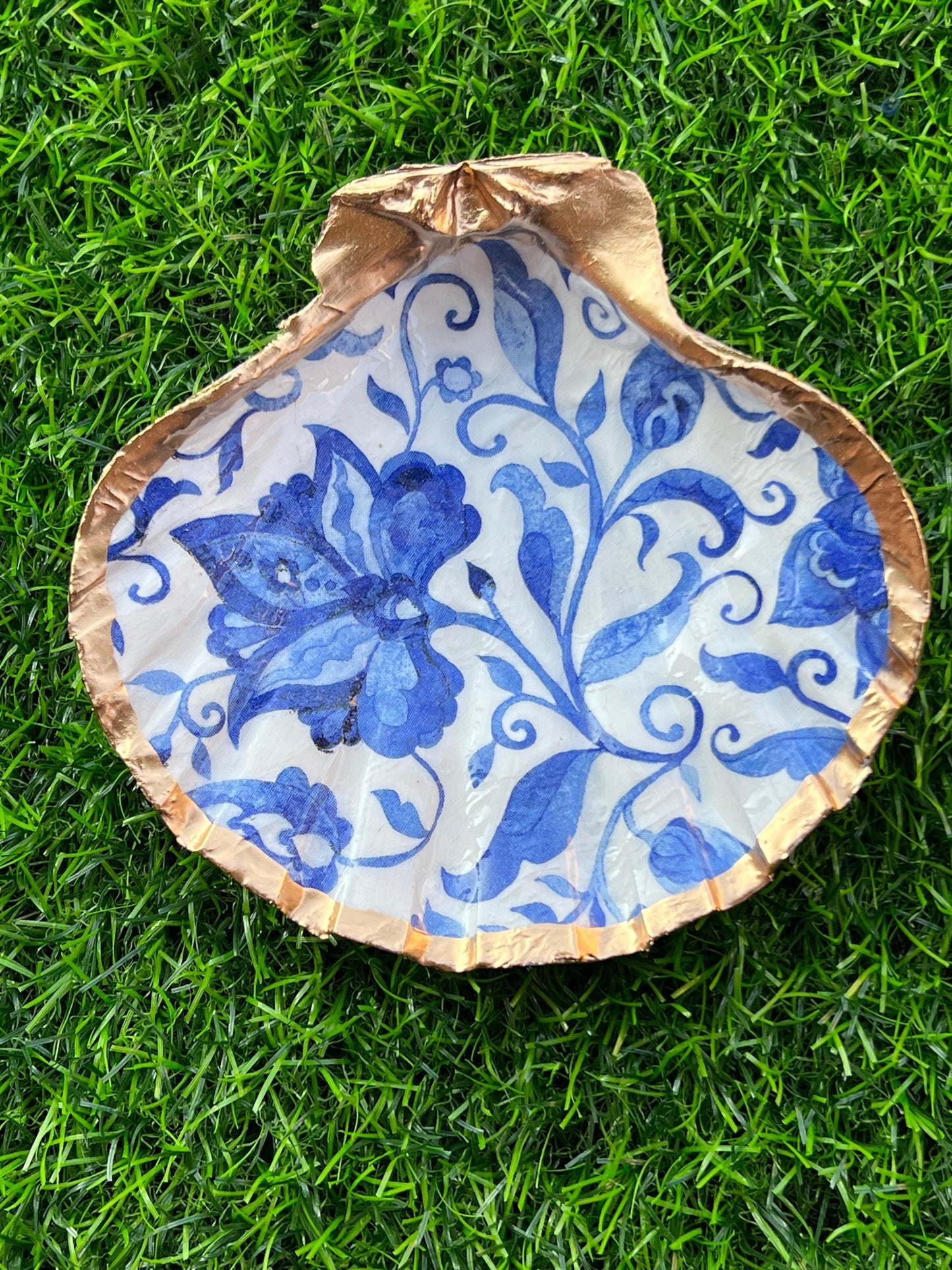 Gold Shell with blue and white floral design