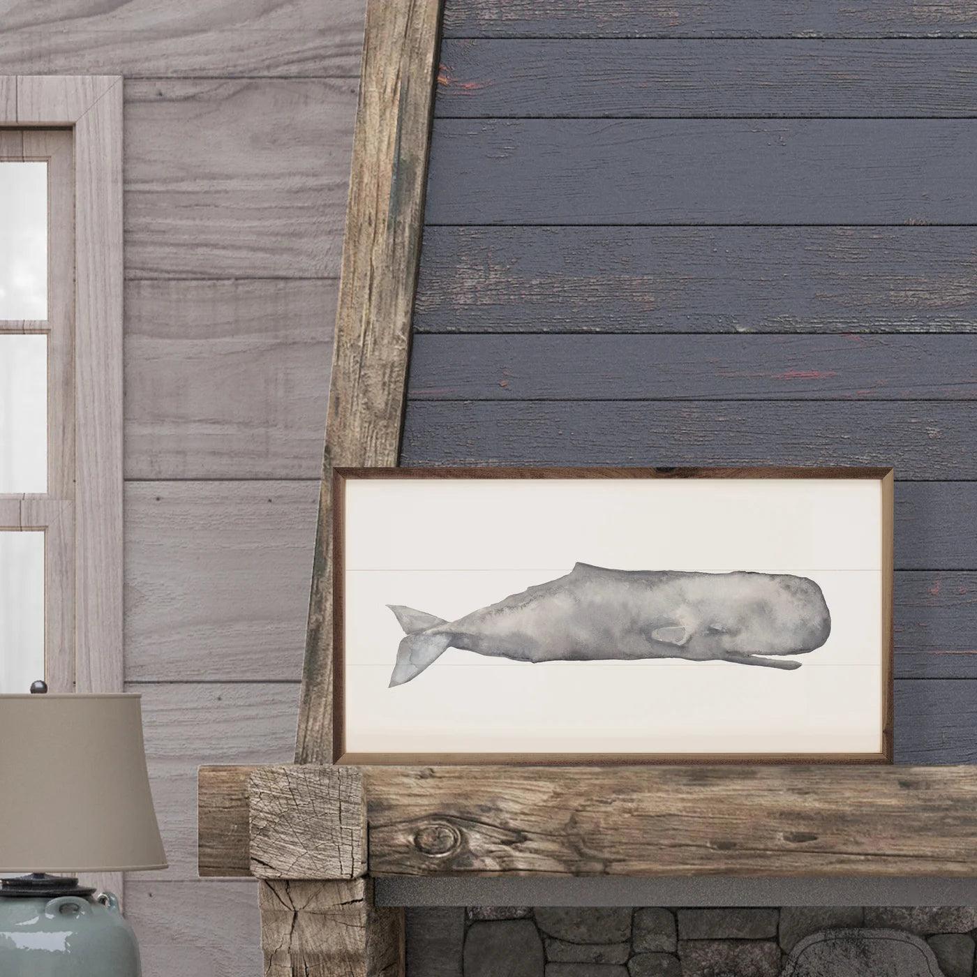 painting of a gray whale on a wood fireplace mantle