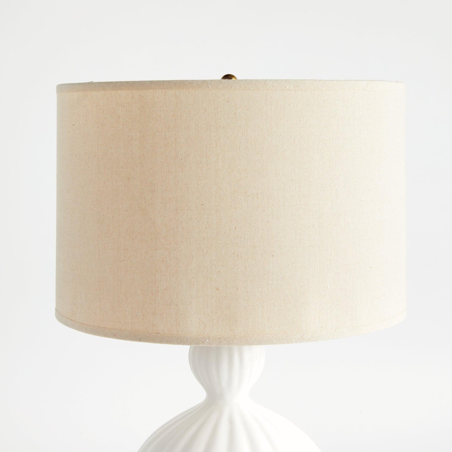 close up of linen shade on white lamp