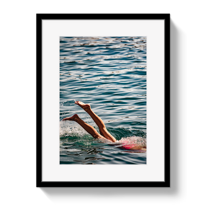 Joy Of Life coastal swimmer photograph in a black frame with a white border