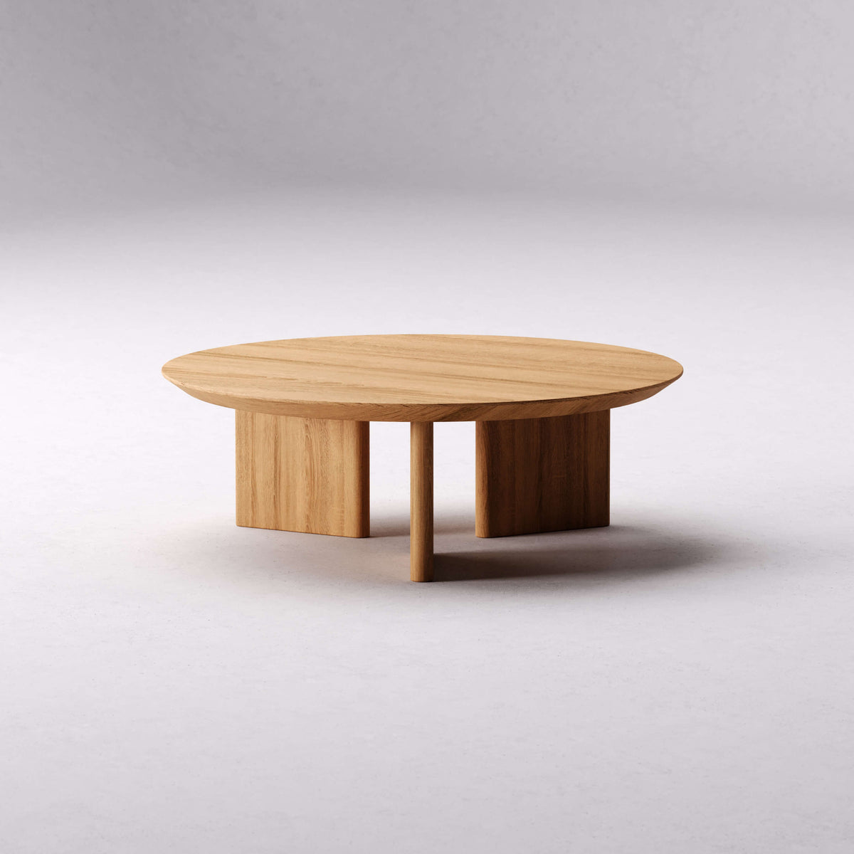 Front view of the Noah coffee table showing its round top and sculptural three-leg base